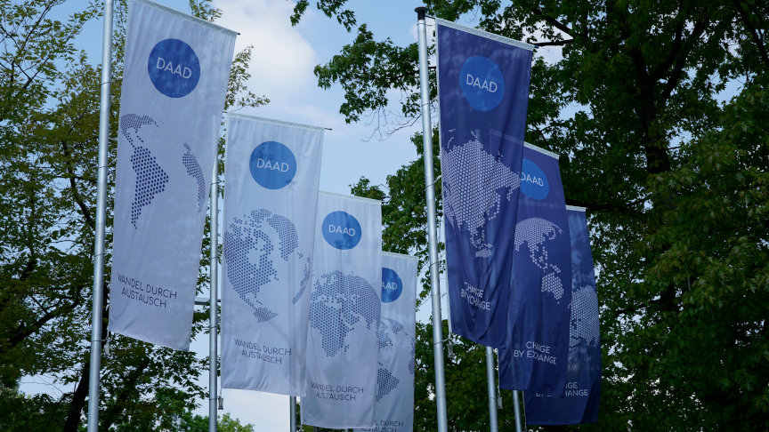 Fahnen mit dem DAAD-Logo vor der Außenfassade der Zentrale in Bonn.
